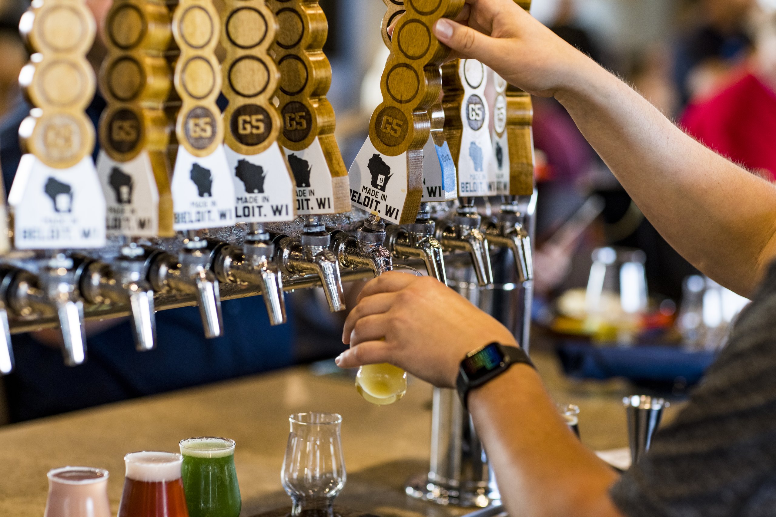 A man pours a craft beer at G5 Brewing