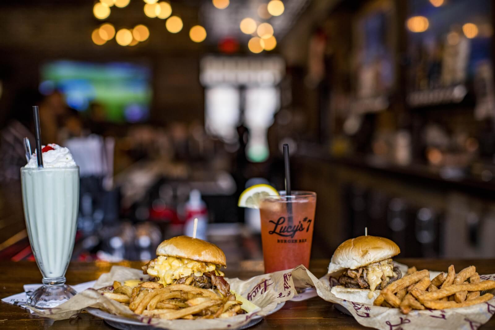 Two cheeseburgers served with fries, soda, and a milkshake at Lucy's Burger Bar in Beloit, WI.