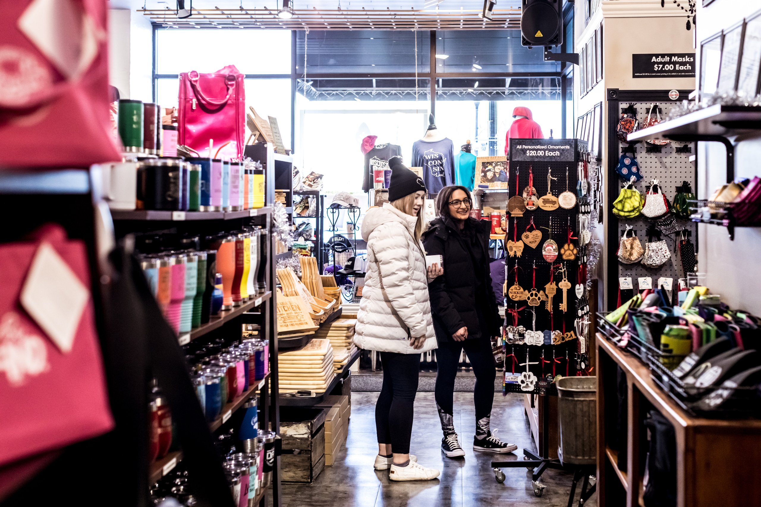 Two women peruse a local boutique while shopping in Beloit, WI. 